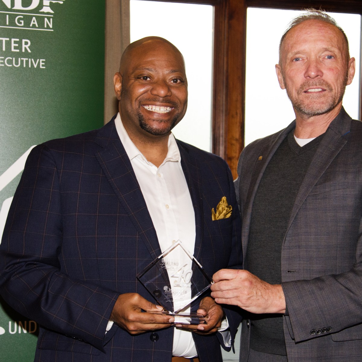 Kermit Williams accepts 40 Under 40 Award from Oakland County Executive