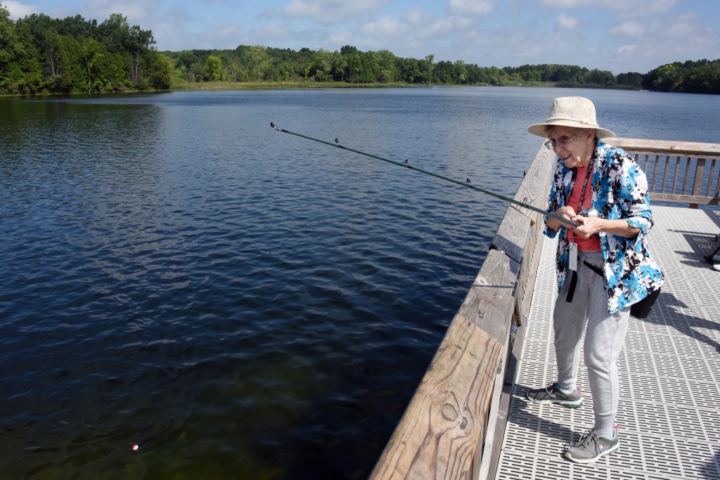 Older adult on a dock fishing