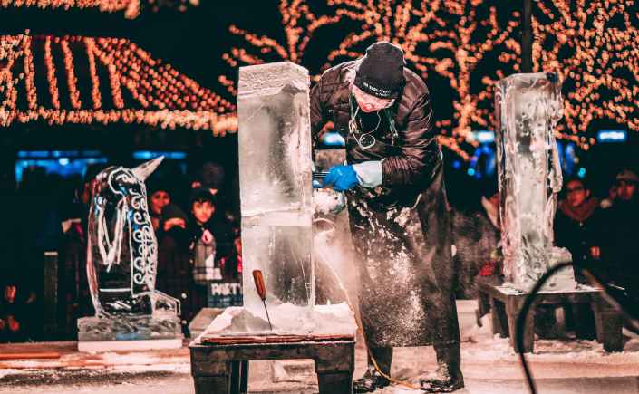 person carving ice sculptures