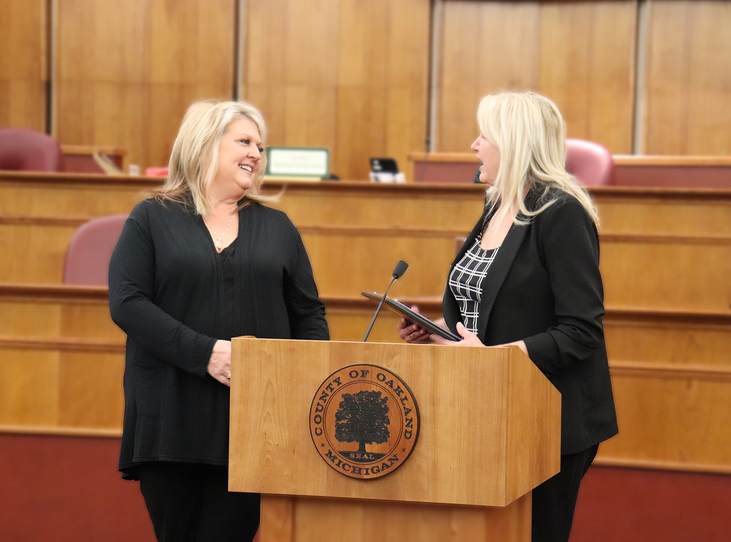 Two women stand at a podium.